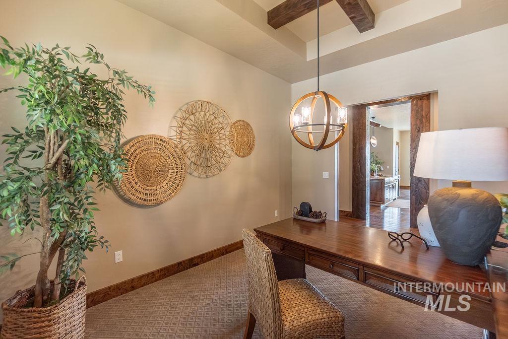 15350 Syrah Court Caldwell, ID 83607 - Photo 40 of 50 Office space featuring a coffered ceiling with exposed wood beams, a globe-style chandelier, and an open doorway with wood trim