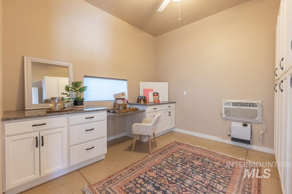15350 Syrah Court Caldwell, ID 83607 - Photo 46 of 50 Versatile workspace featuring white cabinetry with dark hardware, speckled countertops, and a built-in desk area