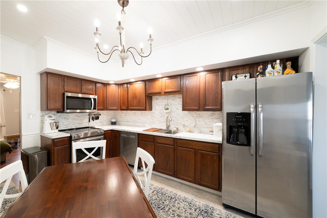 649 Furnace Street Emmaus, PA 18049 - Photo 9 of 24 A galley kitchen with wooden cabinetry and stainless steel appliances is ready for culinary endeavors.