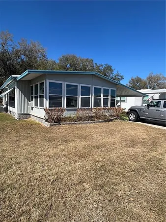 a front view of a house with yard tree and wooden fence
