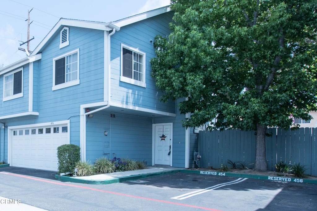 456 West Wooley Road Oxnard, CA 93030 - Photo 1 of 1 a front view of a house with a yard and garage