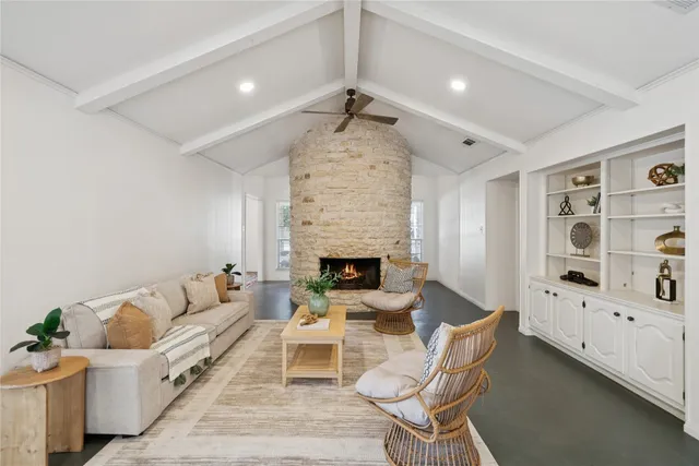 a living room with furniture fireplace and rug