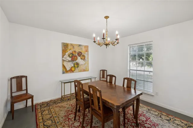 a view of a dining room with furniture and chandelier