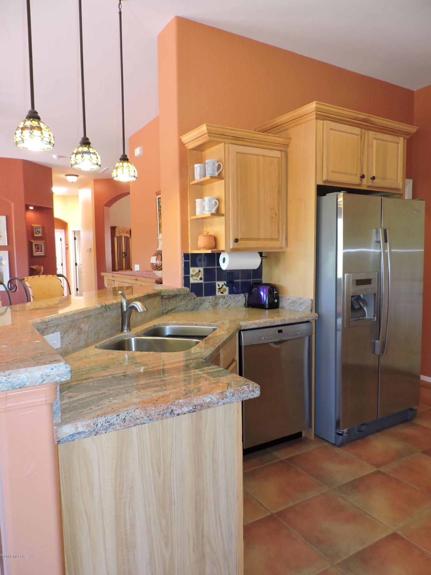 1786 Zimmer Court Rio Rico, AZ 85648 - Photo 27 of 42 a kitchen with stainless steel appliances granite countertop a sink a stove and a refrigerator