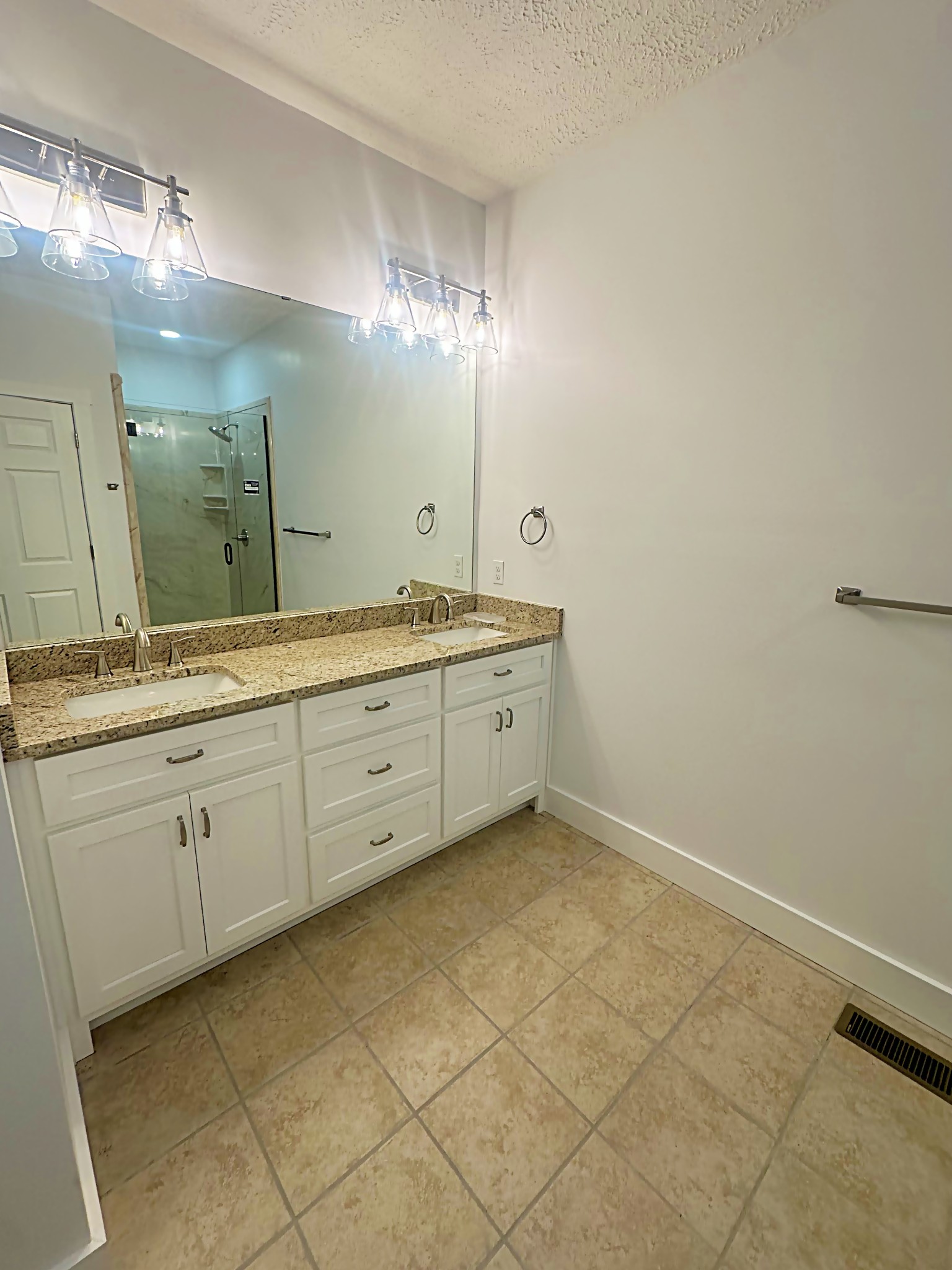 821 Alman Cemetery Road Paris, TN 38242 - Photo 16 of 32 a spacious bathroom with a granite countertop sink a mirror and a