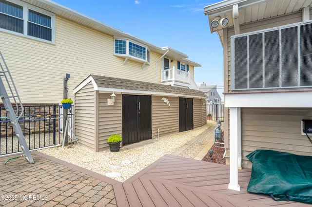 an aerial view of a house with outdoor seating and ocean view