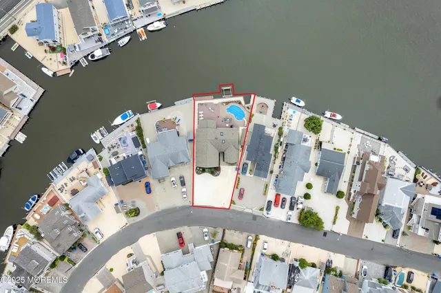 a dining room with furniture a potted plant and wooden floor