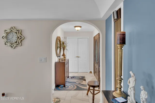 a kitchen with stainless steel appliances kitchen island granite countertop a refrigerator and a sink