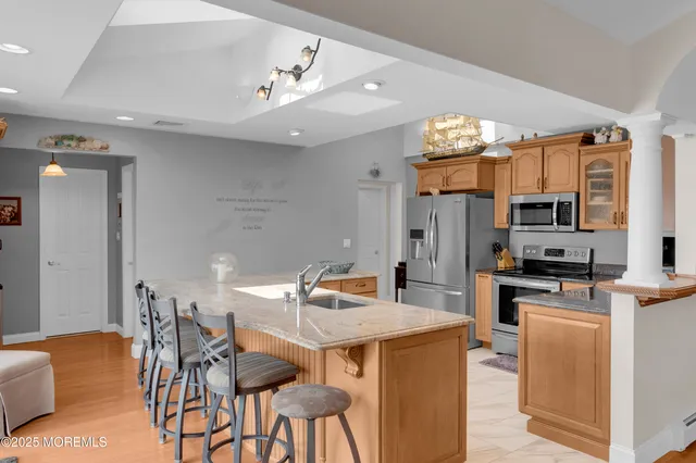 a bathroom with a double vanity sink toilet and shower