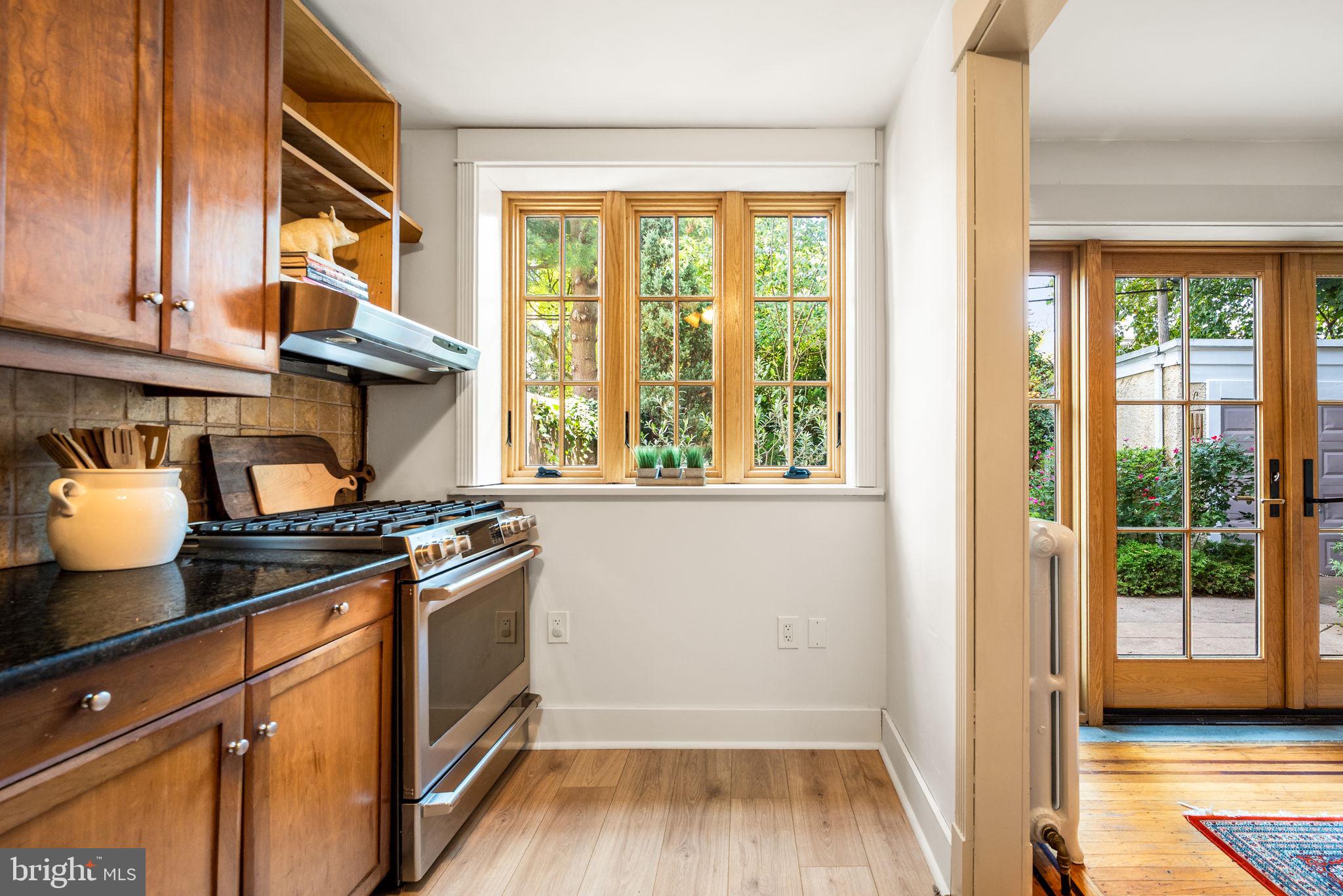 3310 West Penn Street Philadelphia, PA 19129 - Photo 11 of 26 a kitchen with granite countertop a stove and a wooden floor