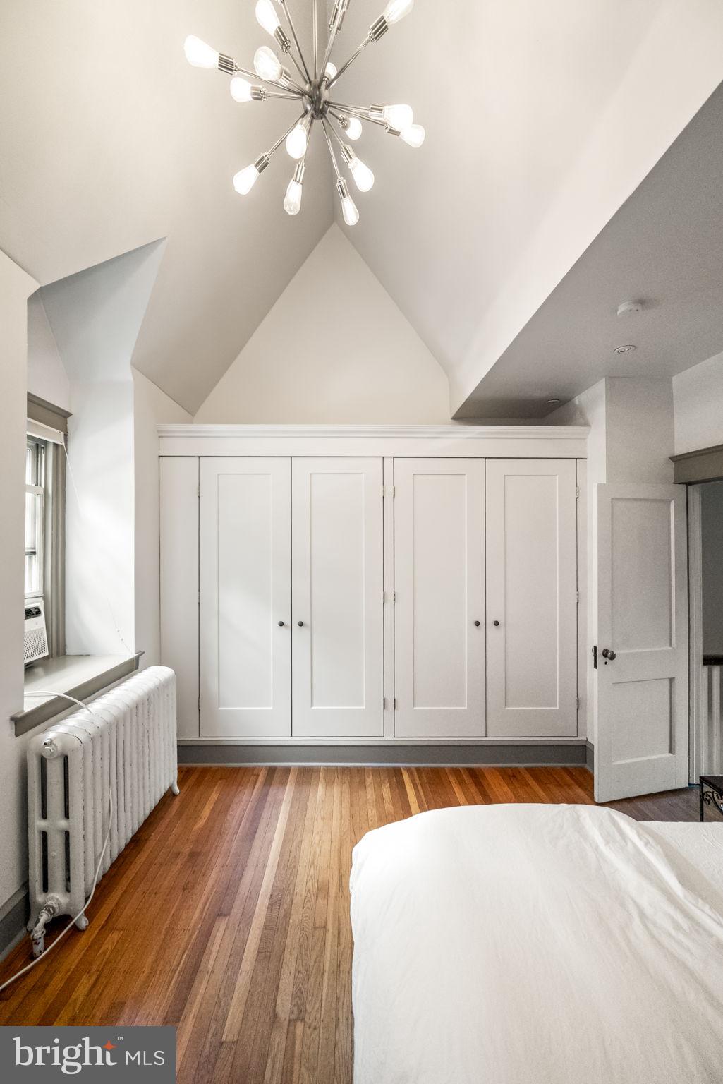 3310 West Penn Street Philadelphia, PA 19129 - Photo 15 of 26 a bedroom with a bed and a chandelier