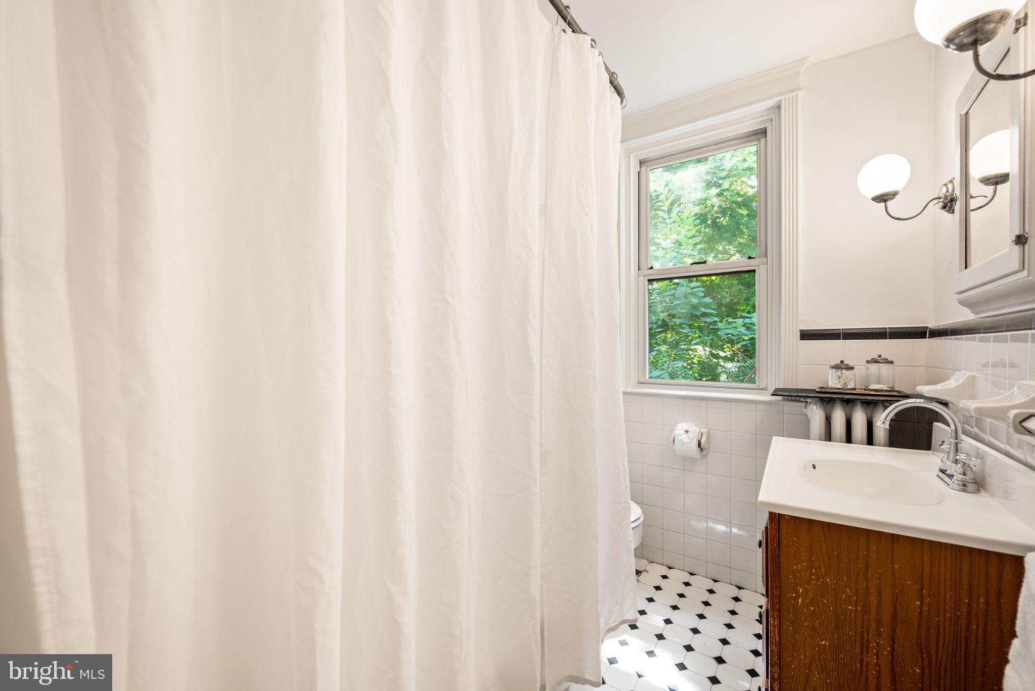 3310 West Penn Street Philadelphia, PA 19129 - Photo 25 of 26 a bathroom with a sink a toilet and a window