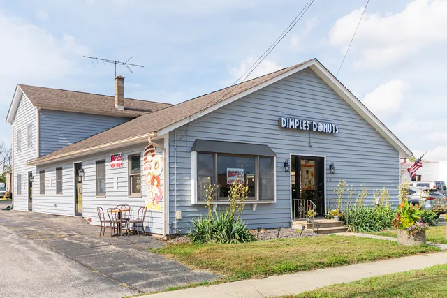 a front view of a house with garden and plants