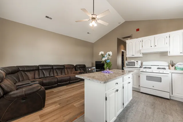 a view of kitchen with cabinets and outdoor living space
