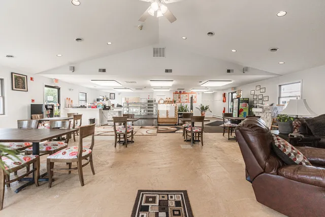 a living room with lots of furniture and white walls