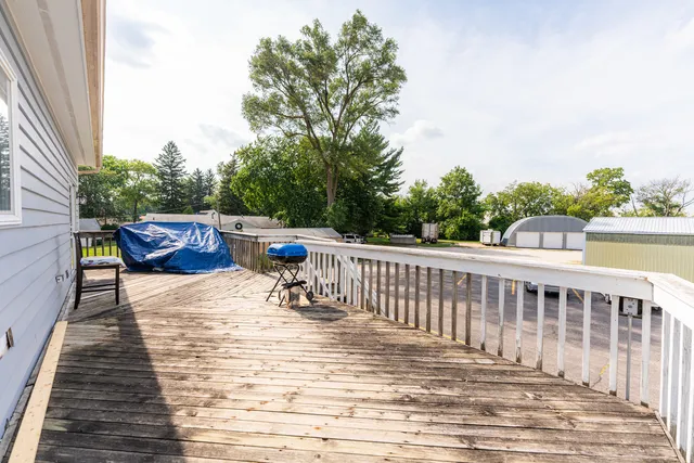 a view of balcony with wooden floor and outdoor seating