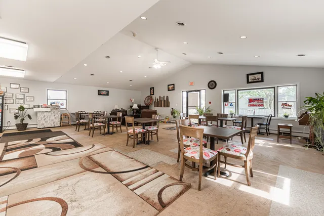 a living room with lots of furniture and view of kitchen