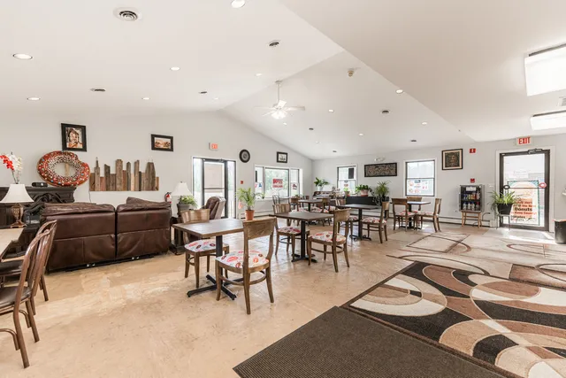 a living room with lots of furniture and view of kitchen