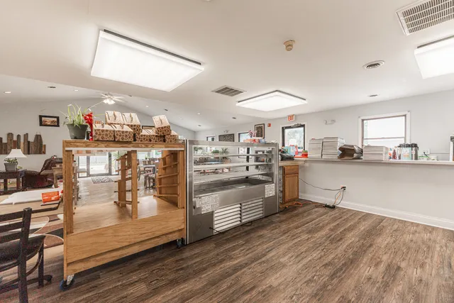 a kitchen view with stainless steel appliances wooden floor and counter space