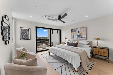 a bedroom with a large bed and a large window