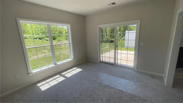 a view of an empty room with windows