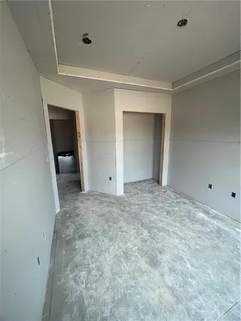 a view of an empty room with a kitchen