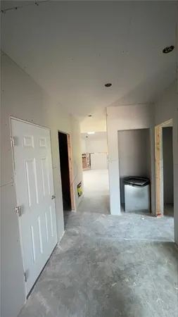 a kitchen with stainless steel appliances a refrigerator a sink and white cabinets