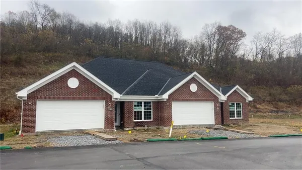a front view of a house with yard
