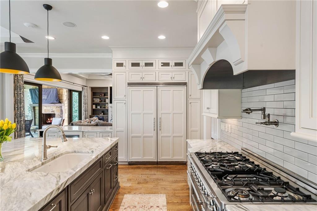 5265 Peachtree Dunwoody Road Sandy Springs, GA 30342 - Photo 11 of 122 a kitchen with stainless steel appliances granite countertop a stove and a sink