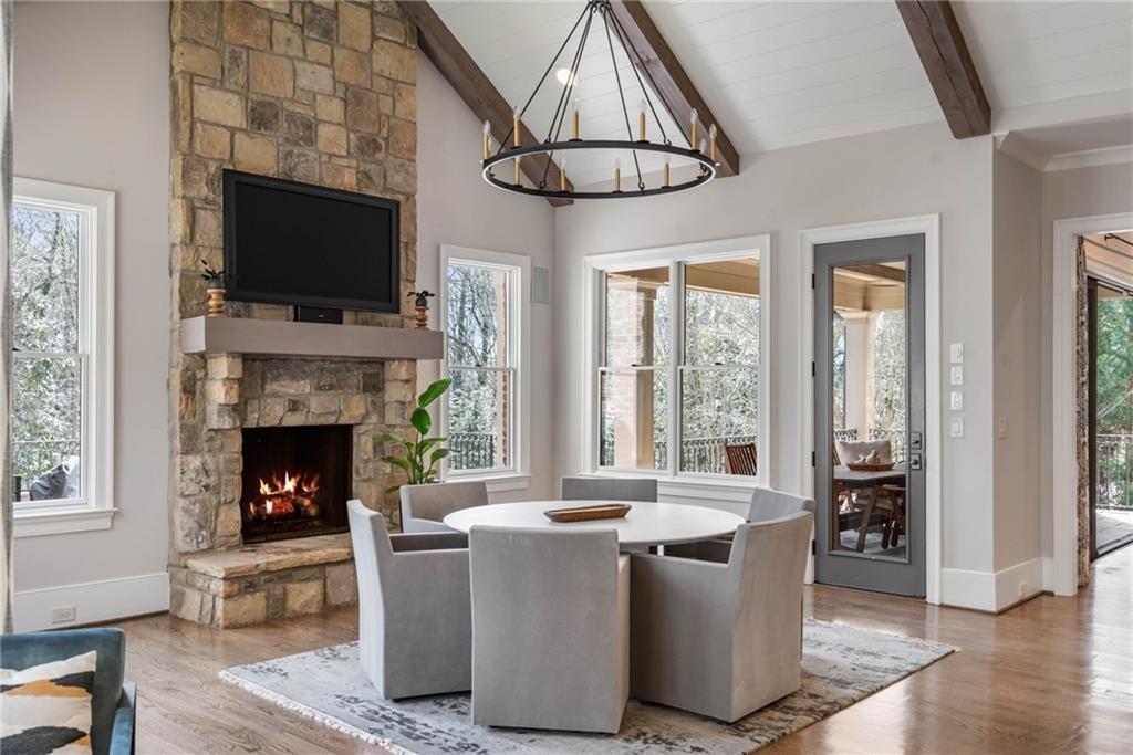 5265 Peachtree Dunwoody Road Sandy Springs, GA 30342 - Photo 12 of 122 a living room with furniture a flat screen tv and a fireplace