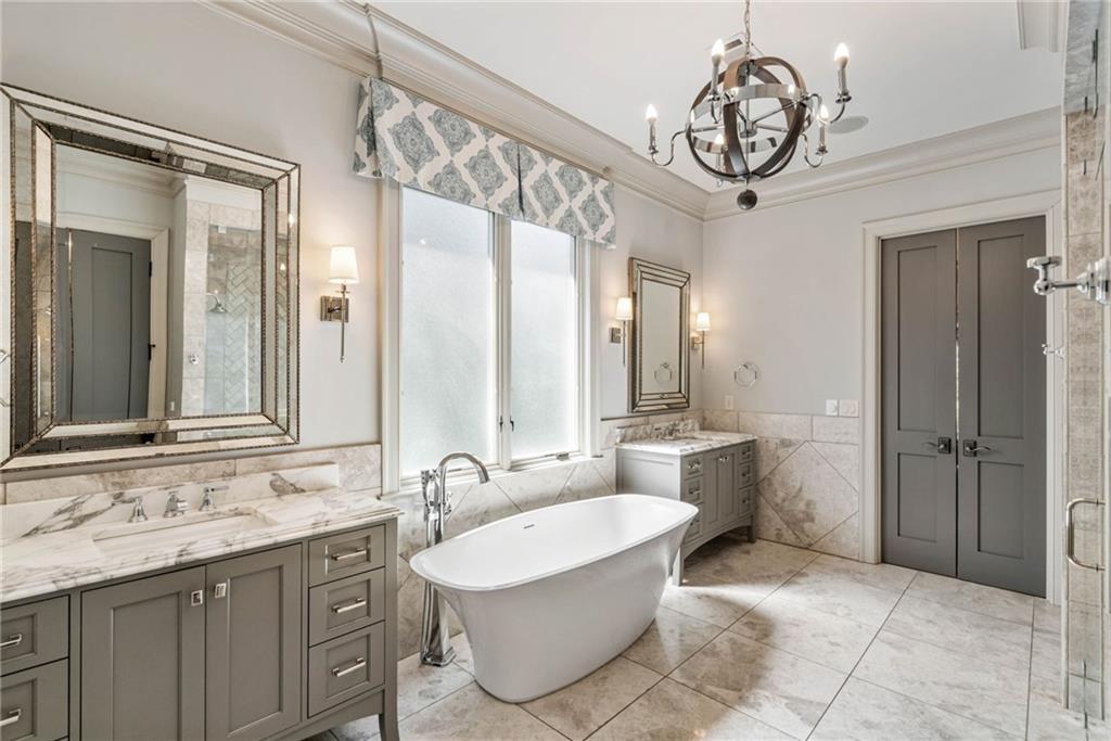 5265 Peachtree Dunwoody Road Sandy Springs, GA 30342 - Photo 15 of 122 a spacious bathroom with a sink a mirror and a large mirror