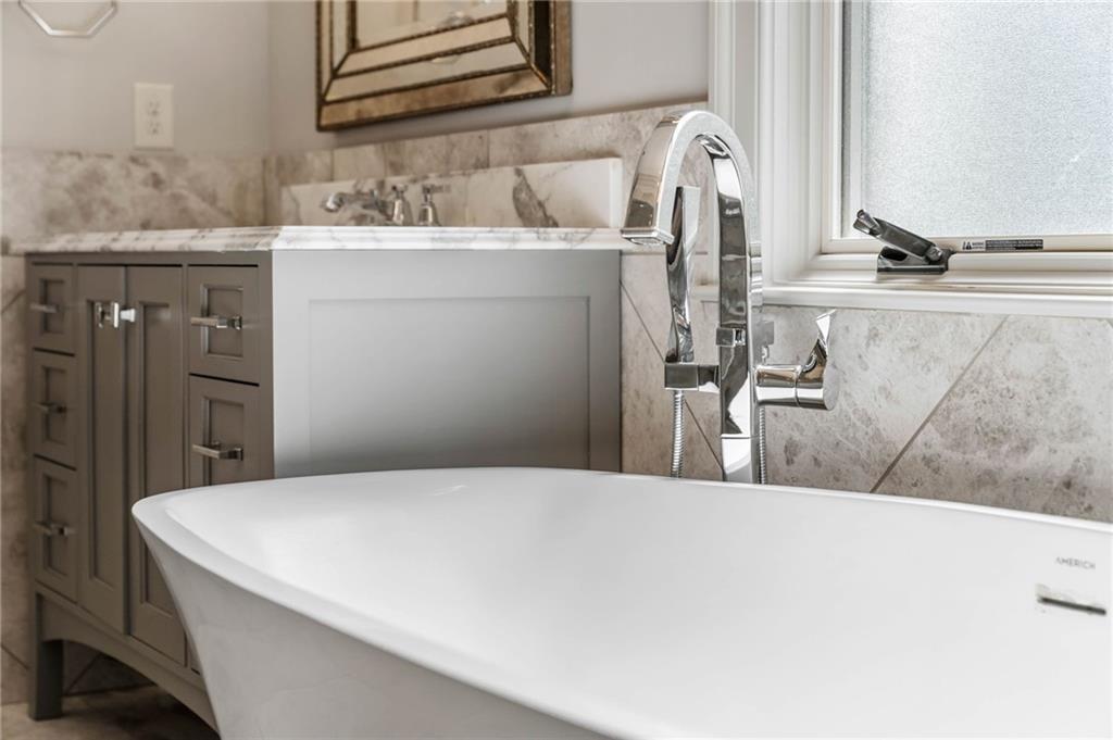 5265 Peachtree Dunwoody Road Sandy Springs, GA 30342 - Photo 16 of 122 a bathroom with a sink and a mirror
