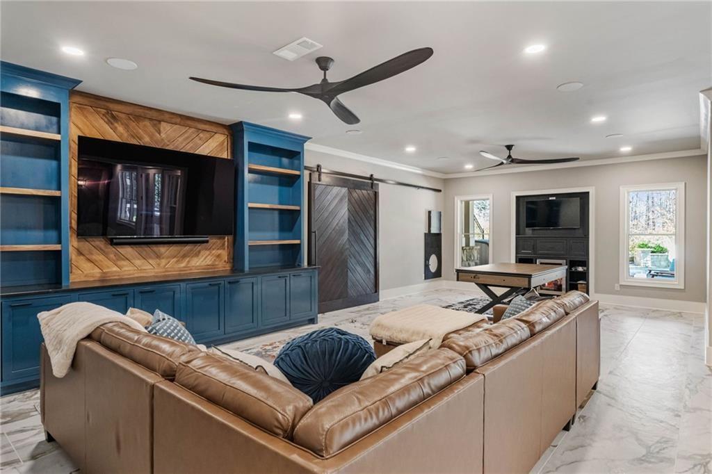 5265 Peachtree Dunwoody Road Sandy Springs, GA 30342 - Photo 31 of 122 a living room with furniture and a flat screen tv