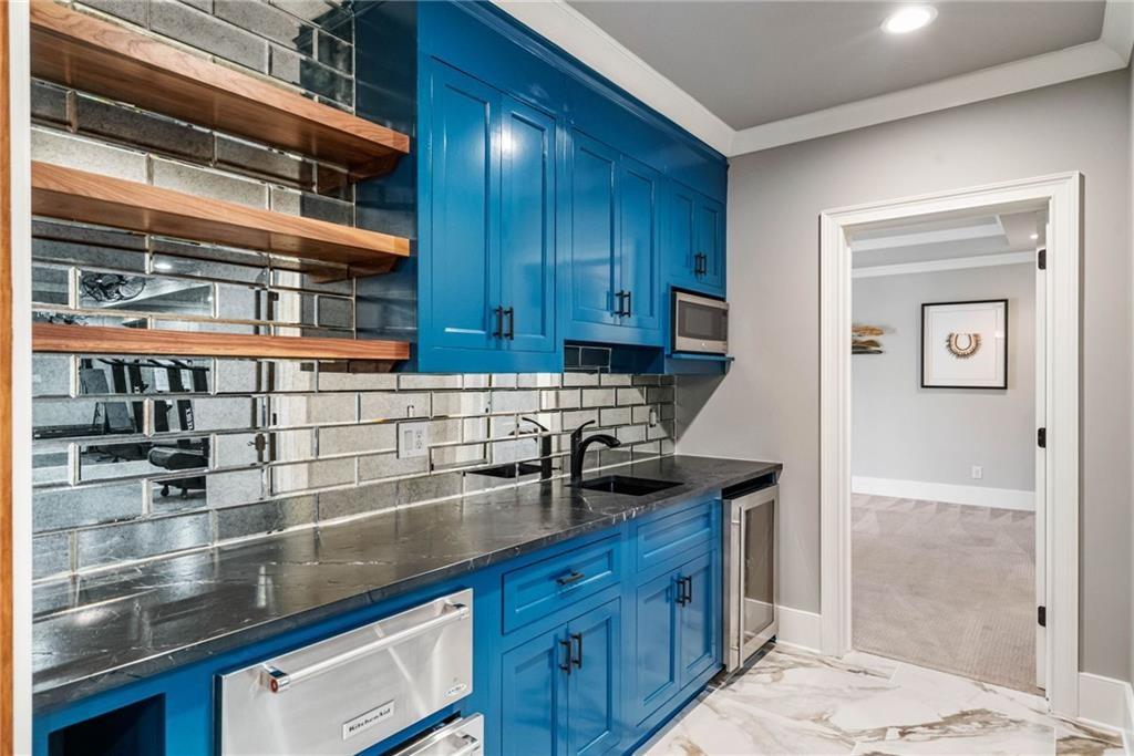 5265 Peachtree Dunwoody Road Sandy Springs, GA 30342 - Photo 34 of 122 a kitchen with stainless steel appliances granite countertop a sink and a stove