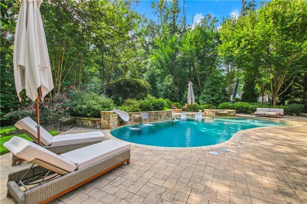 5265 Peachtree Dunwoody Road Sandy Springs, GA 30342 - Photo 4 of 122 a view of a swimming pool with a patio