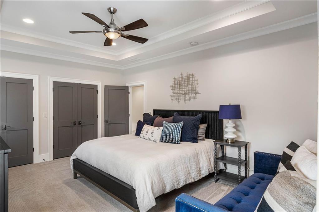 5265 Peachtree Dunwoody Road Sandy Springs, GA 30342 - Photo 41 of 122 a bedroom with bed and a chandelier