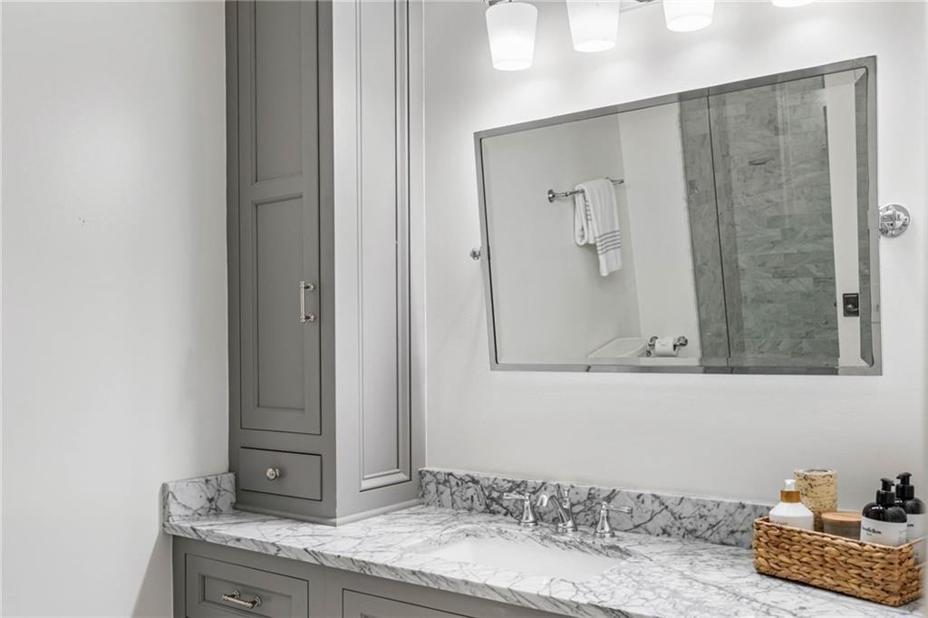 5265 Peachtree Dunwoody Road Sandy Springs, GA 30342 - Photo 42 of 122 a bathroom with a granite countertop sink and a mirror