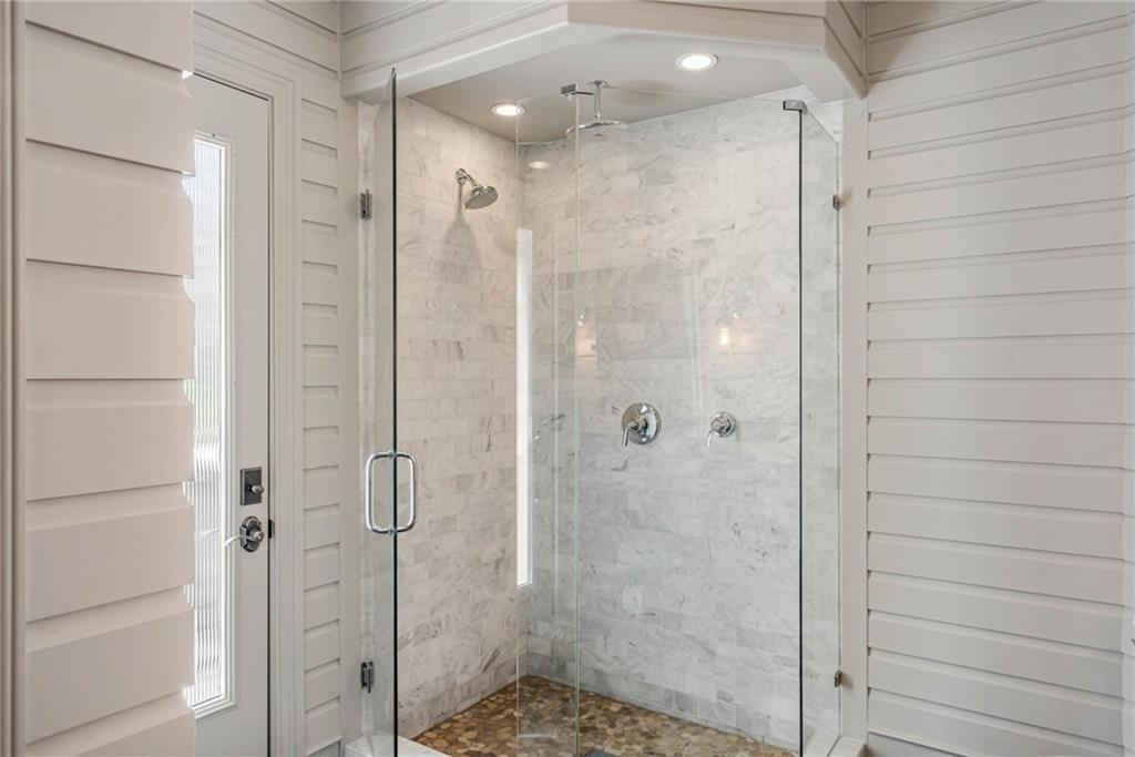 5265 Peachtree Dunwoody Road Sandy Springs, GA 30342 - Photo 47 of 122 a bathroom with a shower and a glass door