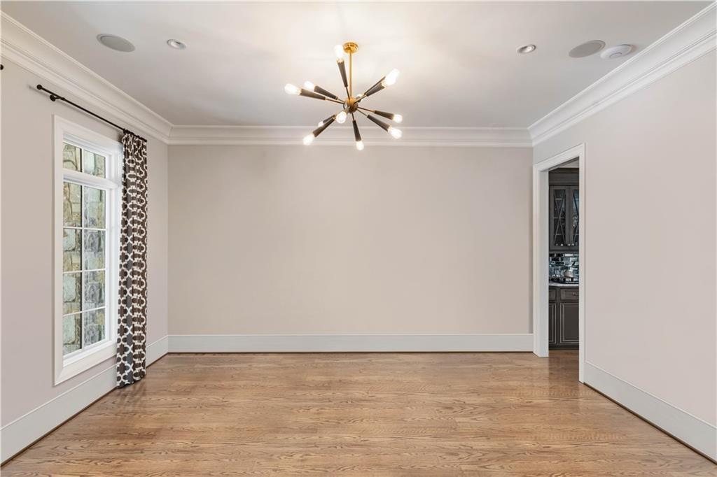 5265 Peachtree Dunwoody Road Sandy Springs, GA 30342 - Photo 51 of 122 a view of an empty room with window and chandelier fan
