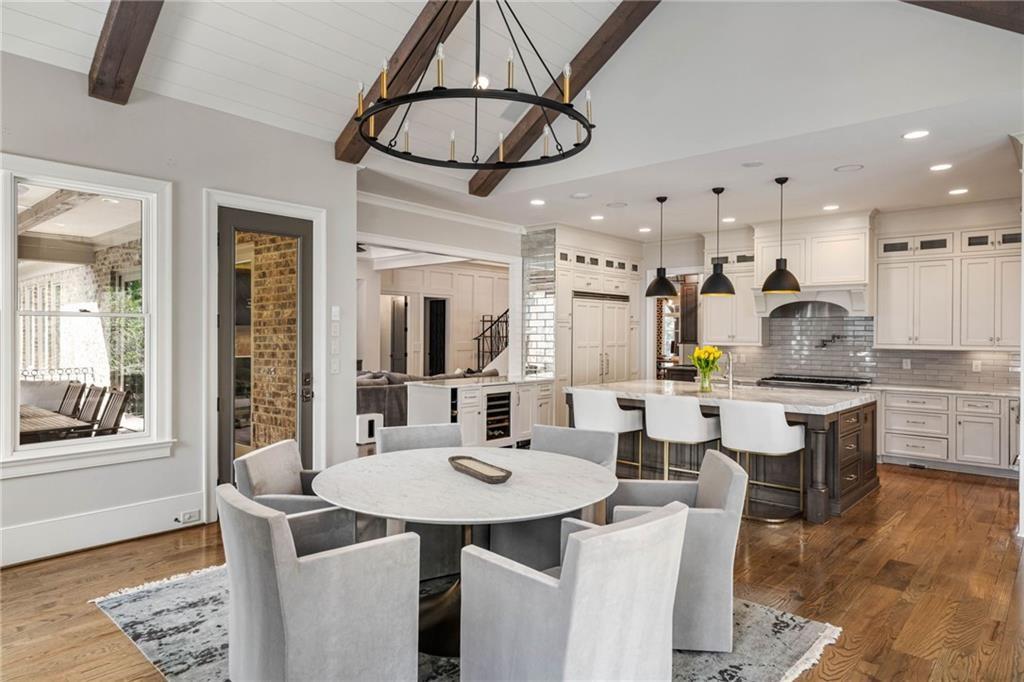 5265 Peachtree Dunwoody Road Sandy Springs, GA 30342 - Photo 6 of 122 a dining hall with stainless steel appliances kitchen island a table and chairs in it