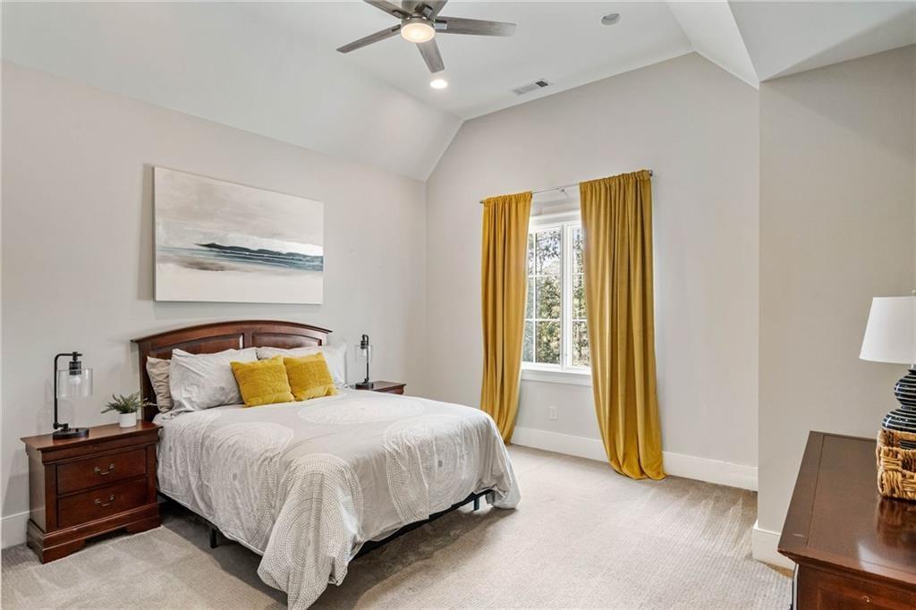 5265 Peachtree Dunwoody Road Sandy Springs, GA 30342 - Photo 61 of 122 a bedroom with a bed and a chandelier