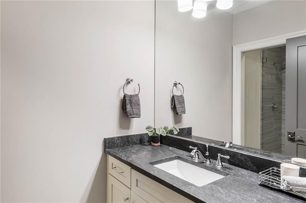 5265 Peachtree Dunwoody Road Sandy Springs, GA 30342 - Photo 63 of 122 a bathroom with a granite countertop sink and a mirror