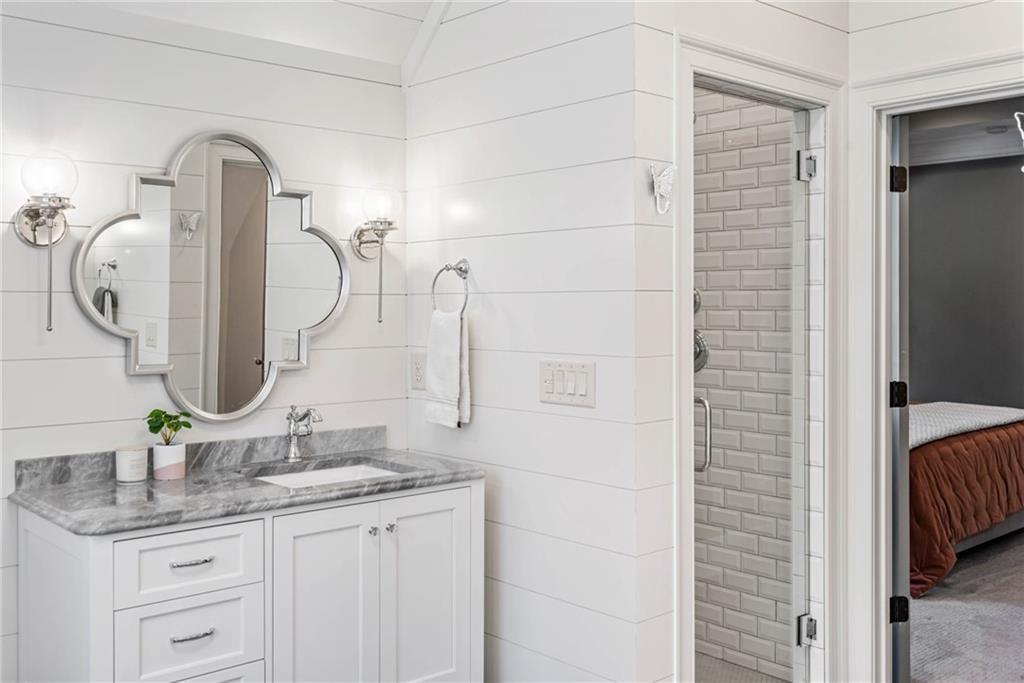 5265 Peachtree Dunwoody Road Sandy Springs, GA 30342 - Photo 68 of 122 a bathroom with a granite countertop sink and a mirror