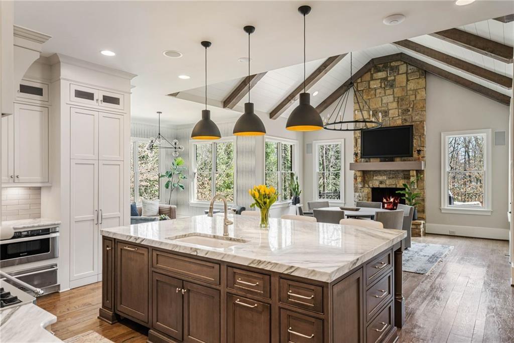 5265 Peachtree Dunwoody Road Sandy Springs, GA 30342 - Photo 7 of 122 a kitchen with stainless steel appliances granite countertop a sink a stove and a wooden floors