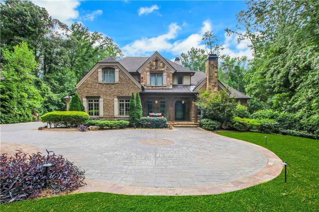 5265 Peachtree Dunwoody Road Sandy Springs, GA 30342 - Photo 89 of 122 a front view of a house with a yard and garage