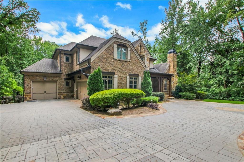 5265 Peachtree Dunwoody Road Sandy Springs, GA 30342 - Photo 92 of 122 a front view of a house with a yard and garage