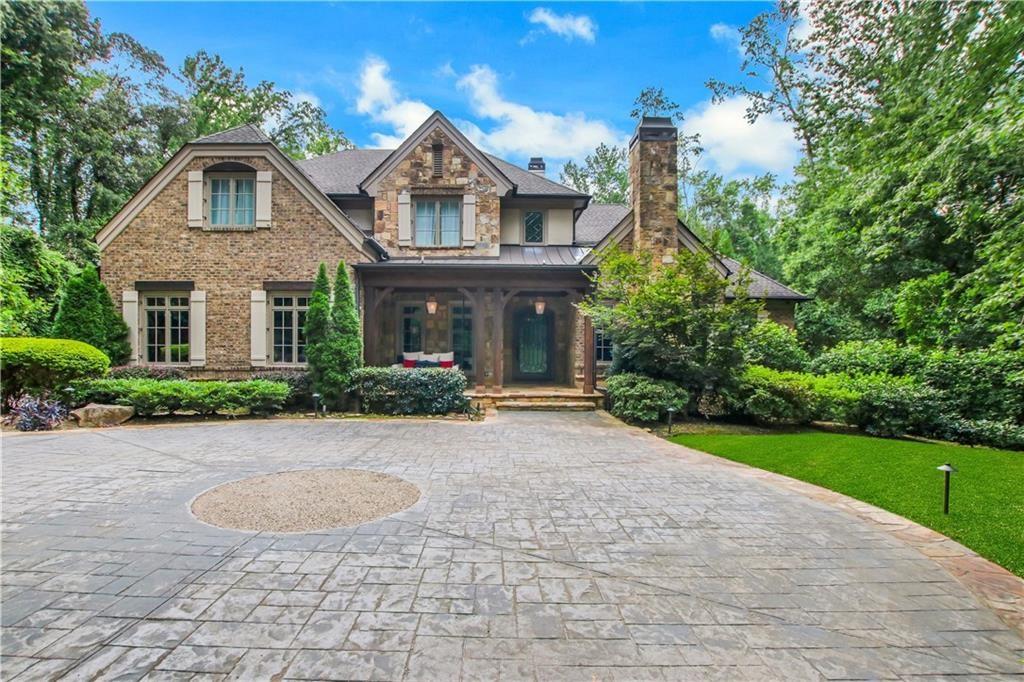 5265 Peachtree Dunwoody Road Sandy Springs, GA 30342 - Photo 94 of 122 a front view of a house with a yard and trees