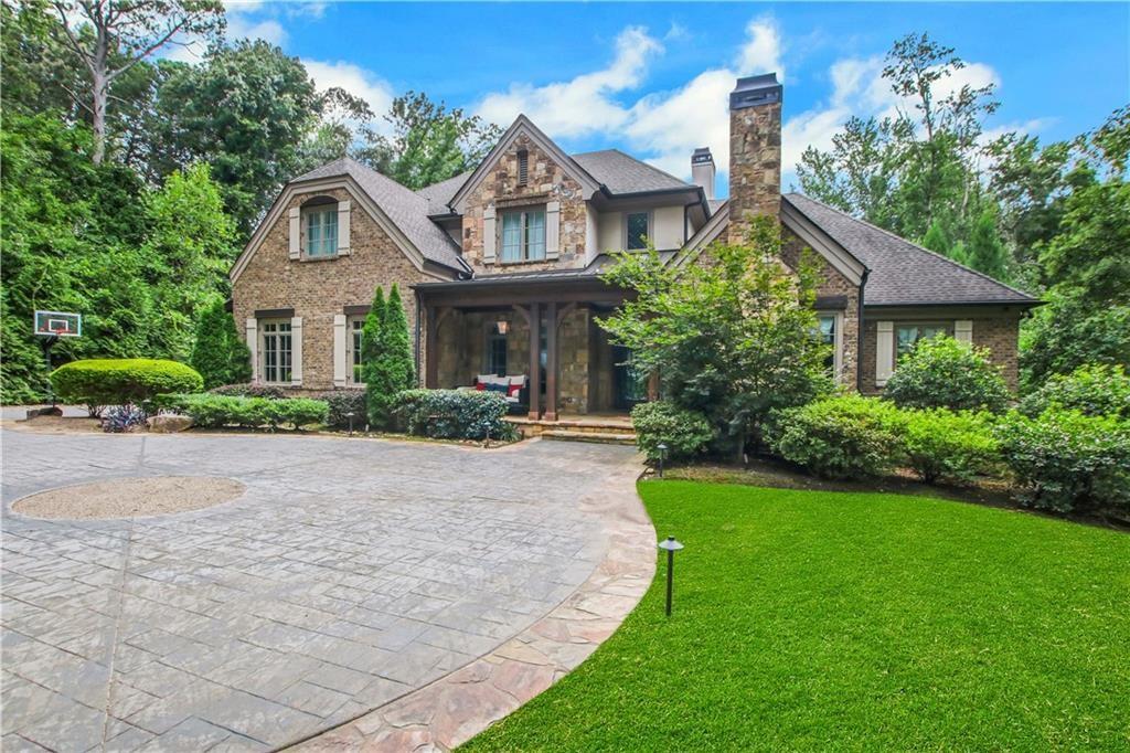 5265 Peachtree Dunwoody Road Sandy Springs, GA 30342 - Photo 95 of 122 a front view of a house with a yard and trees