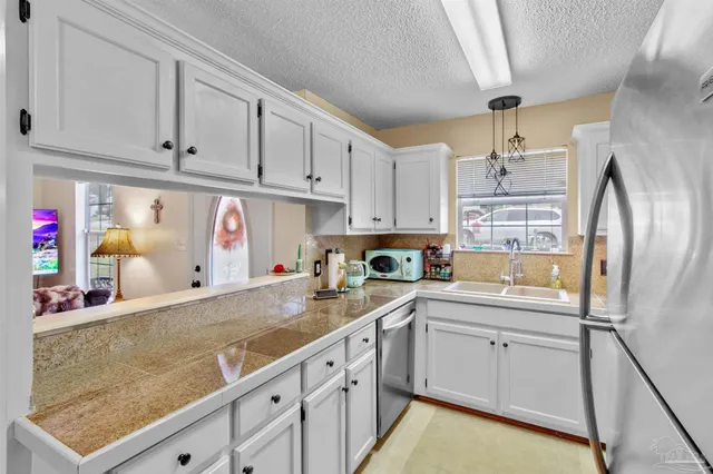 a kitchen with cabinets and window