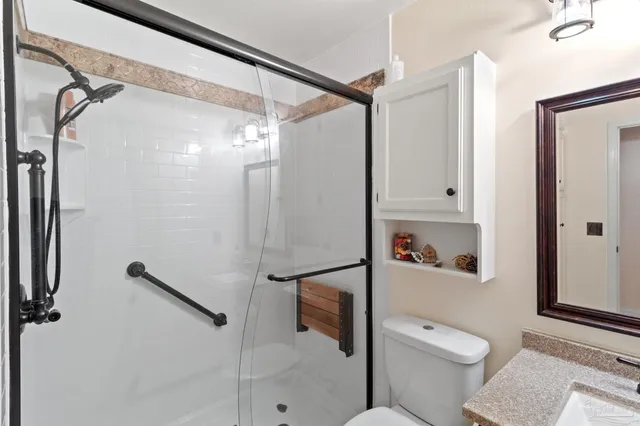 a bathroom with a shower a toilet and a sink